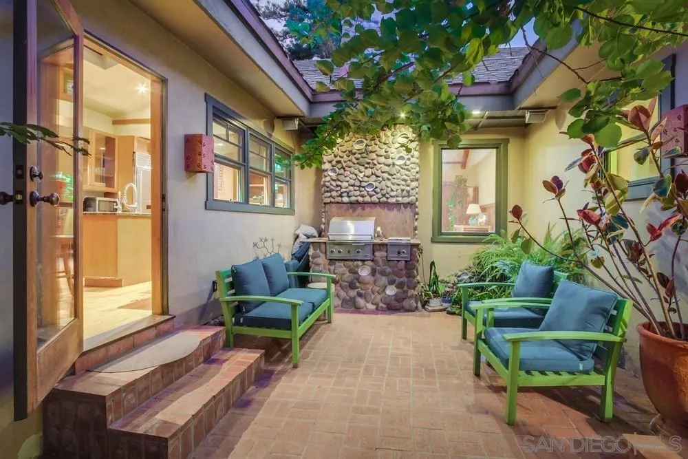 a living room filled with furniture and a potted plant