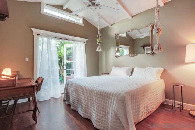 a bedroom with a bed and a desk