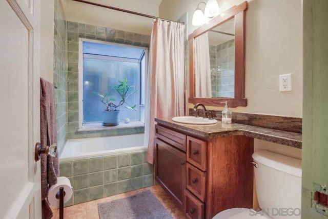 a bathroom with a tub a sink and mirror