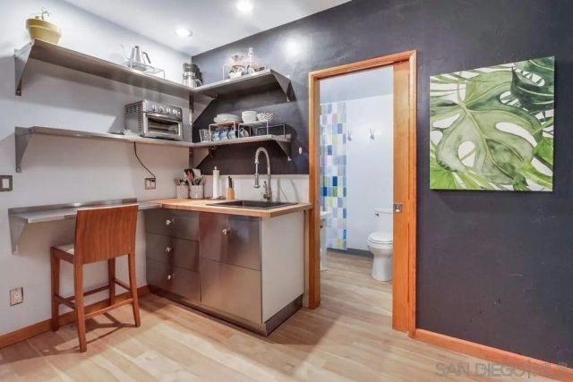 a kitchen with stainless steel appliances granite countertop a refrigerator and a stove