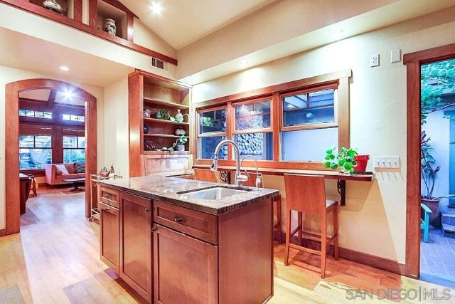 a kitchen with stainless steel appliances granite countertop a sink and a refrigerator