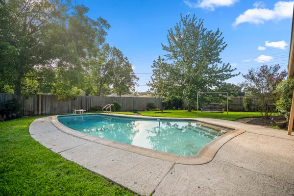 a view of a swimming pool with a yard