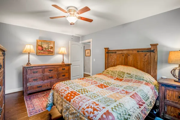 a bedroom with a bed and a dresser in it