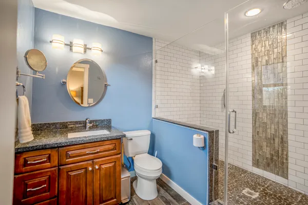 a bathroom with a toilet a sink and a mirror