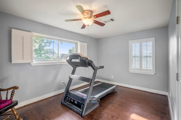 a room with gym equipment and a large window