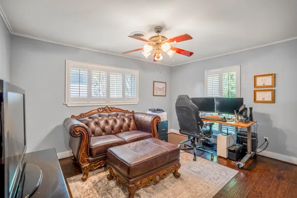 a living room with furniture a rug and a window