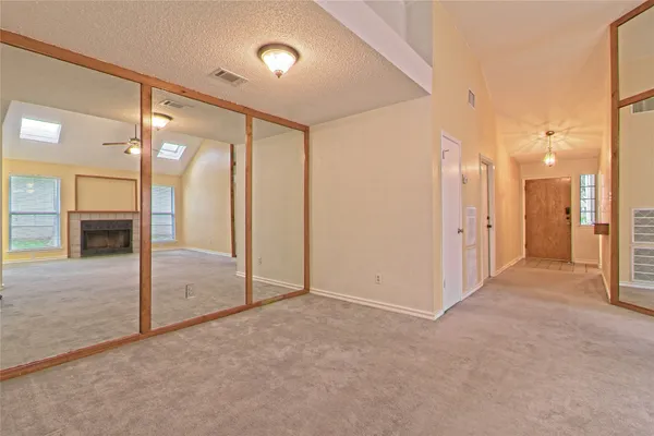 a view of a hallway with wooden shelves