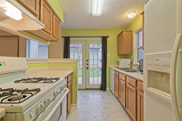 a kitchen with a stove and a refrigerator