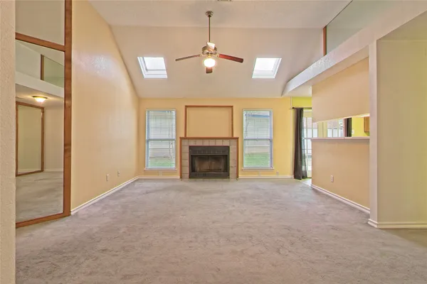 a view of an empty room with a fireplace