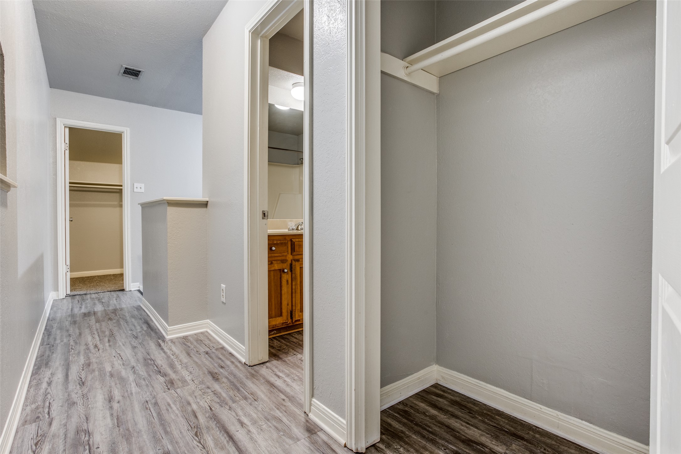 106 Verna Spur, Unit B Georgetown, TX 78628 - Photo 21 of 25 Hallway with durable flooring connecting to a closet and bathroom.