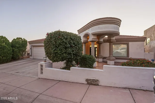 a living room with furniture a fireplace and a chandelier