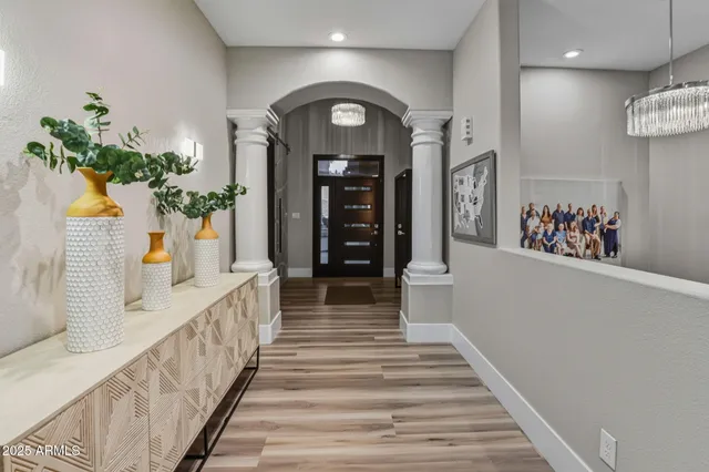 a kitchen with stainless steel appliances granite countertop a stove a refrigerator a sink a stove a dining table and chairs