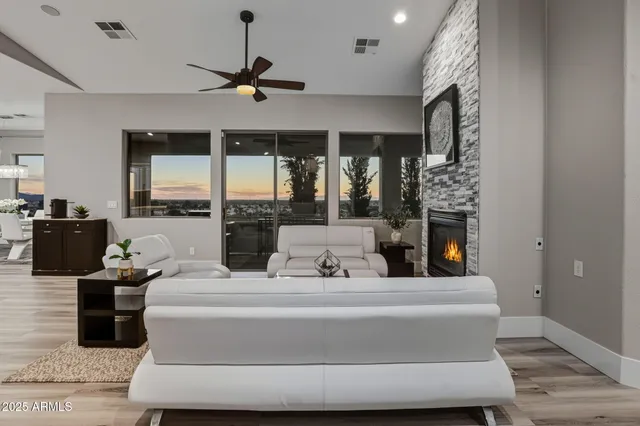 a view of a room with wooden floor and a ceiling fan