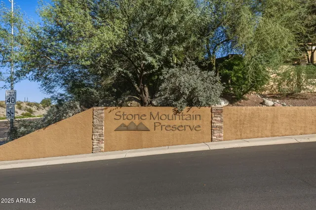 a living room with a bed and a flat screen tv