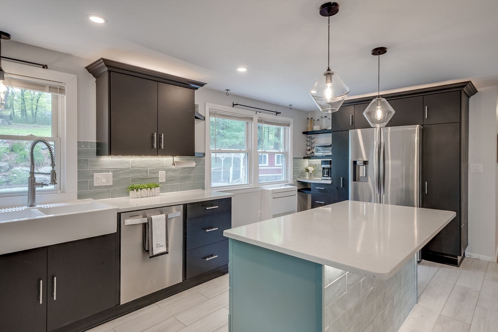 87 Salem Road Billerica, MA 01821 - Photo 3 of 31 a kitchen with stainless steel appliances a sink center island and windows