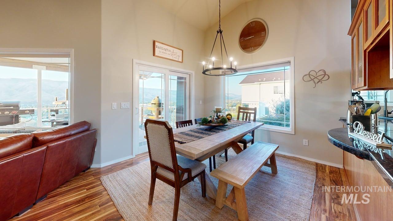 1724 Ridgeview Drive Clarkston, WA 99403 - Photo 12 of 48 Dining space with wood finished floors, high vaulted ceiling, and a chandelier