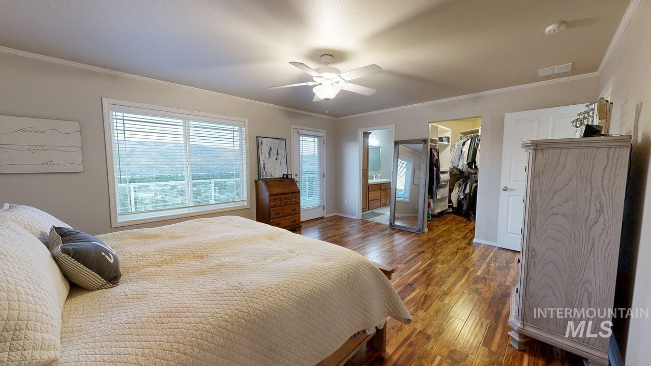 1724 Ridgeview Drive Clarkston, WA 99403 - Photo 18 of 48 Bedroom featuring ornamental molding, multiple windows, wood finished floors, a spacious closet, and ensuite bathroom
