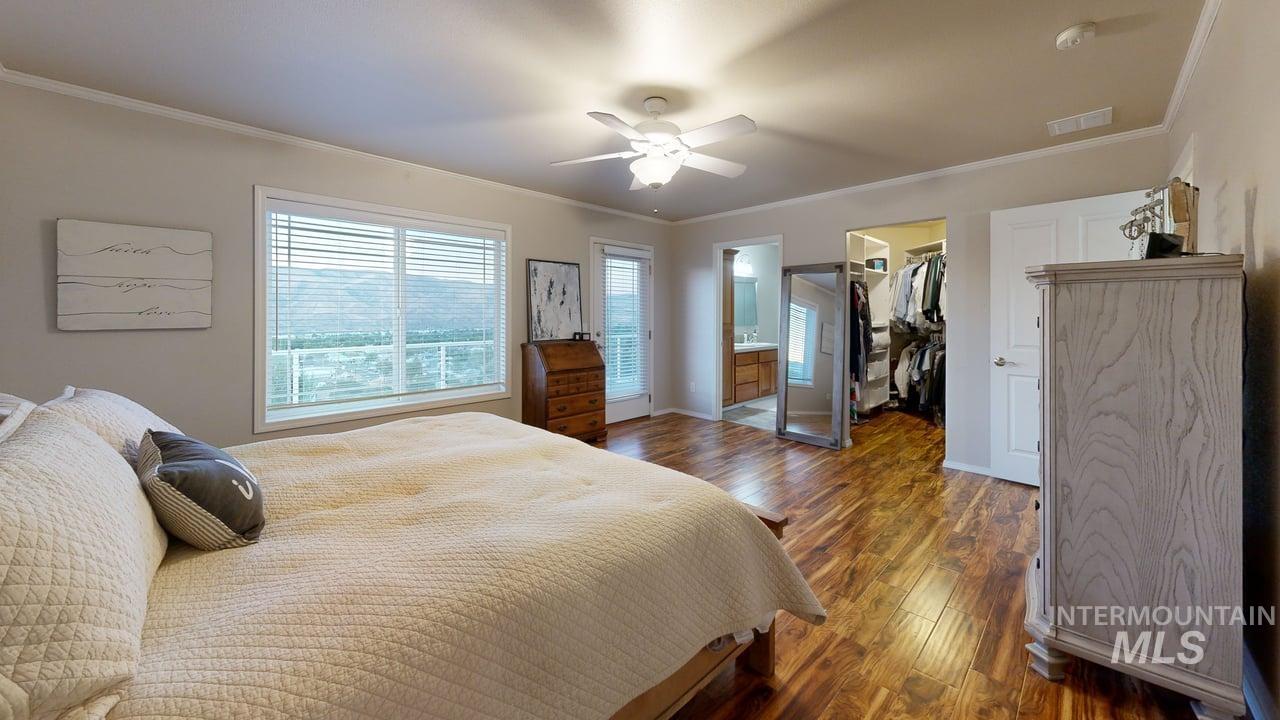 1724 Ridgeview Drive Clarkston, WA 99403 - Photo 20 of 48 Bedroom featuring ornamental molding, hardwood / wood-style flooring, ensuite bathroom, a spacious closet, and a ceiling fan
