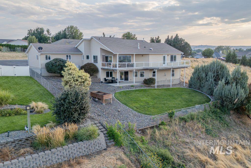 1724 Ridgeview Drive Clarkston, WA 99403 - Photo 2 of 48 Rear view of house featuring a patio, a lawn, a balcony, and a fire pit