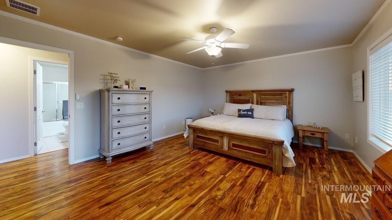 1724 Ridgeview Drive Clarkston, WA 99403 - Photo 21 of 48 Bedroom featuring crown molding, dark wood-style floors, and a ceiling fan