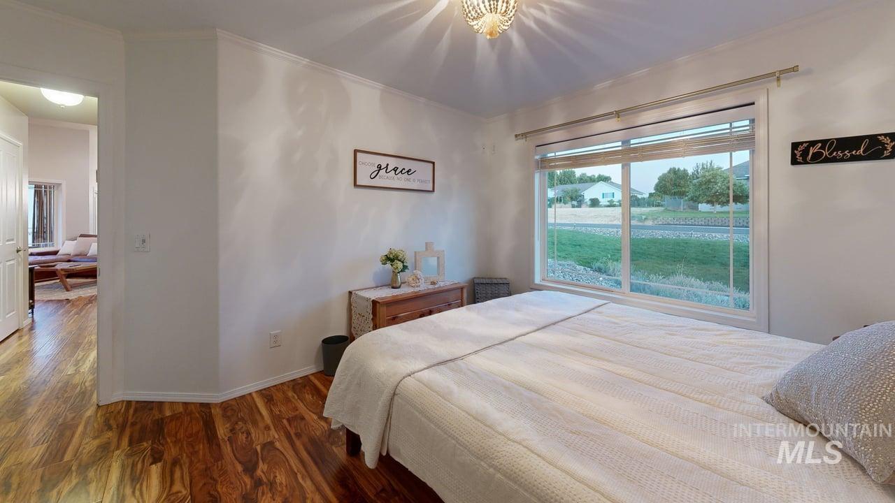 1724 Ridgeview Drive Clarkston, WA 99403 - Photo 24 of 48 Bedroom with dark wood-style flooring and crown molding