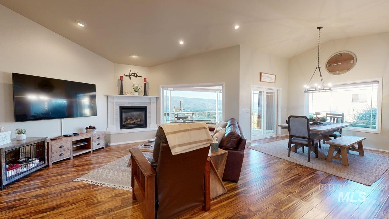 1724 Ridgeview Drive Clarkston, WA 99403 - Photo 4 of 48 Living room featuring vaulted ceiling, recessed lighting, wood finished floors, a glass covered fireplace, and a chandelier