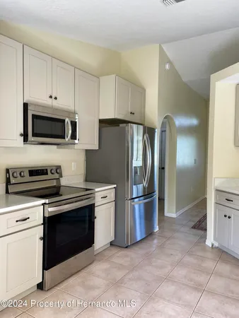 a kitchen with stainless steel appliances granite countertop a stove a refrigerator and a sink