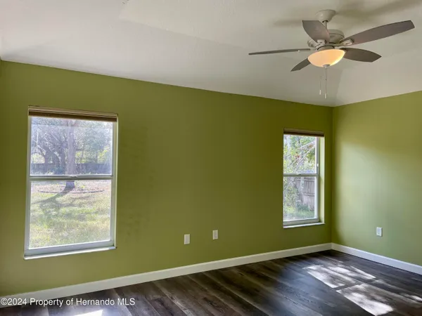 a view of room with window and ceiling fan