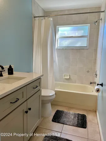 a bathroom with a sink a toilet and a bathtub
