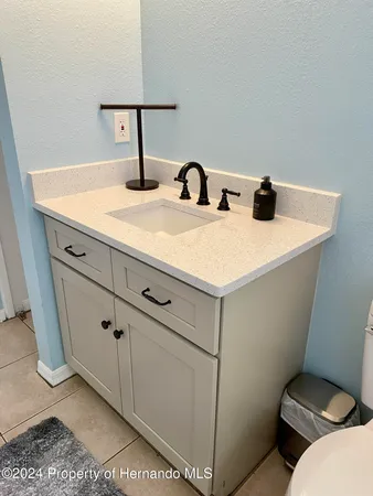 a bathroom with a sink and mirror