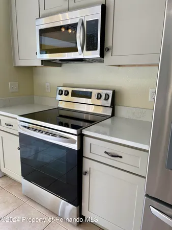 a kitchen with a stove microwave and sink