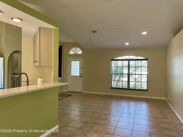 a view of a kitchen with a sink and a large window