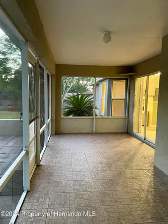 a view of an empty room with a large window
