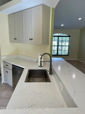 a kitchen with a sink and cabinets