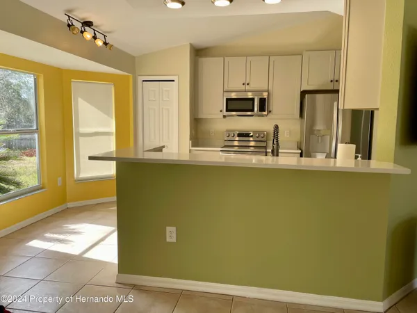 a kitchen with stainless steel appliances a refrigerator and a stove top oven