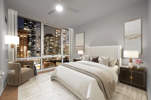 a bedroom with a large bed and a large window