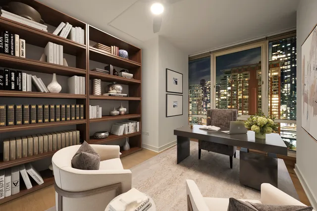 a living room with furniture and a book shelf