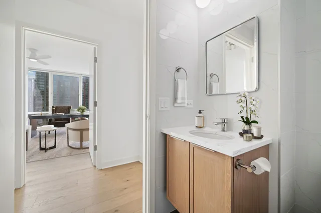 a bathroom with a sink vanity and a mirror