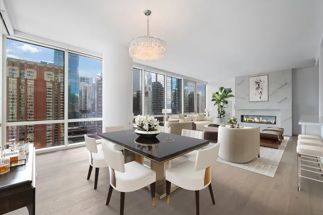 a view of a dining room with furniture wooden floor and a chandelier