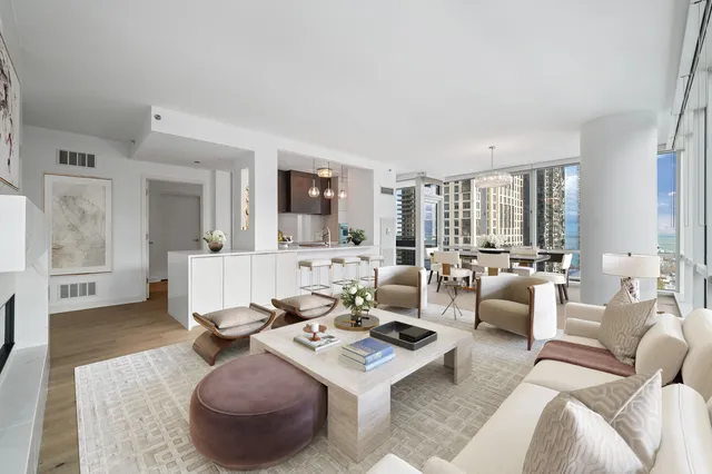 a living room with furniture a rug and a large window