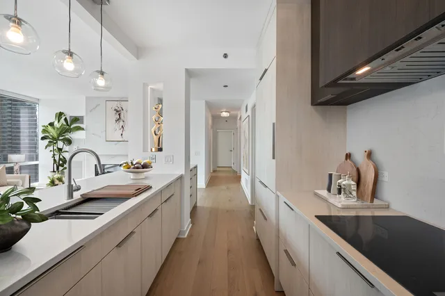 a view of a kitchen with a sink and refrigerator