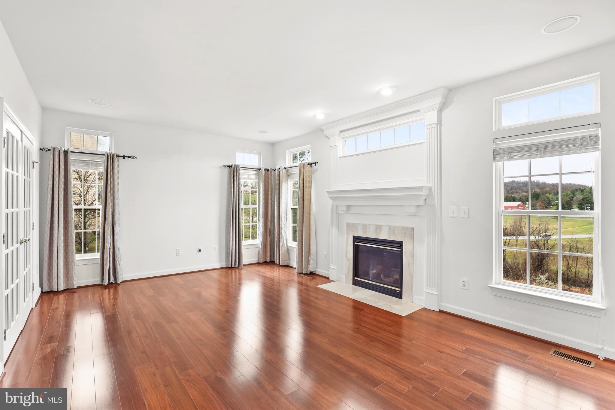 28 Fawn Hill Road Hanover, PA 17331 - Photo 12 of 69 a view of an empty room with wooden floor fireplace and a window