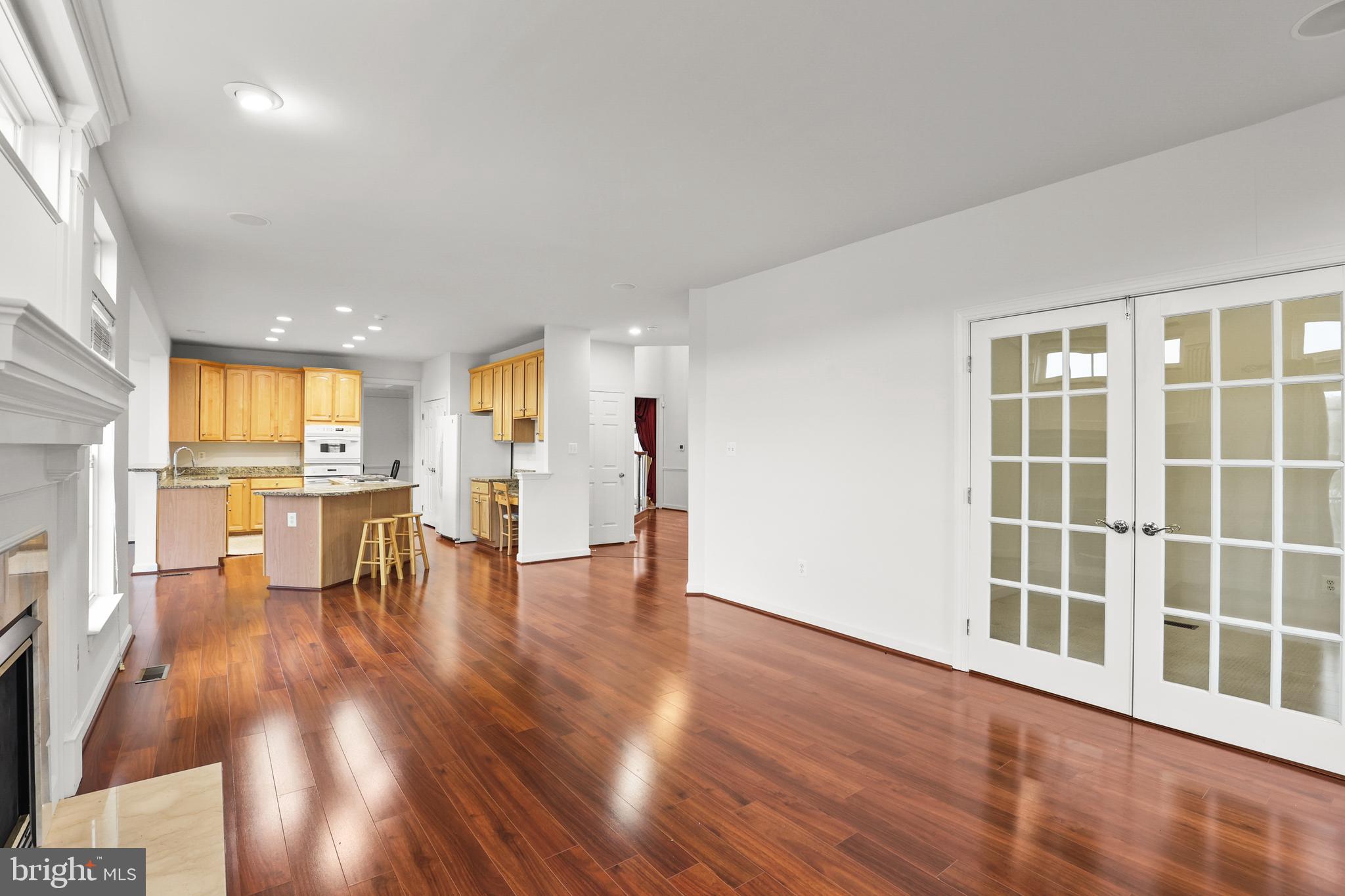 28 Fawn Hill Road Hanover, PA 17331 - Photo 16 of 69 a view of an empty room with wooden floor and a kitchen