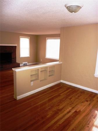 945 Wilbraham Road Springfield, MA 01109 - Photo 4 of 16 an empty room with wooden floor and a window