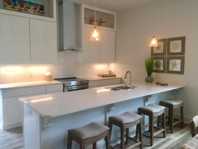115 West Cobia Run Seacrest, FL 32461 - Photo 26 of 26 a kitchen with a table chairs sink and cabinets