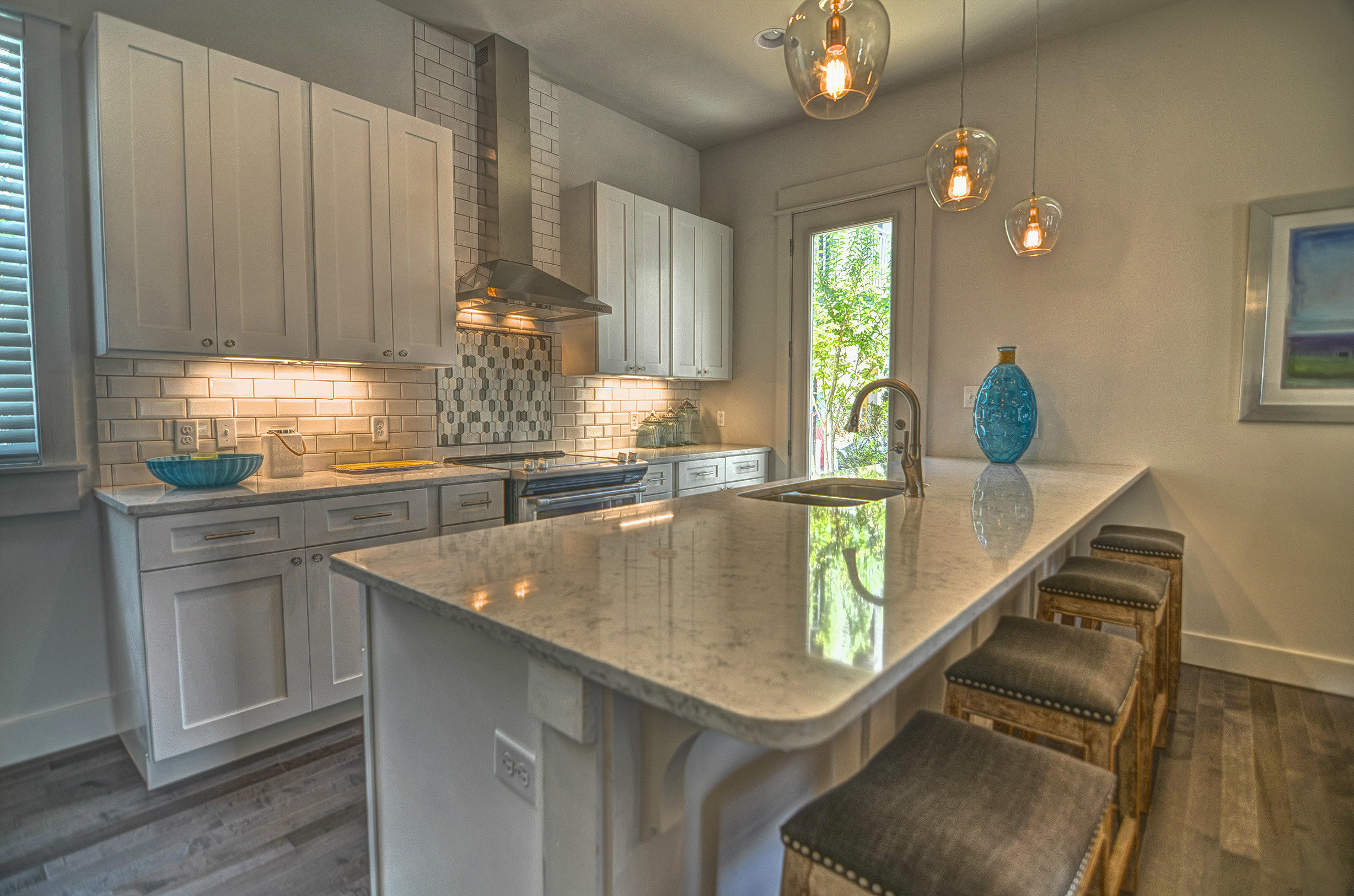 115 West Cobia Run Seacrest, FL 32461 - Photo 7 of 26 a kitchen with stainless steel appliances granite countertop a sink dishwasher and cabinets with wooden floor