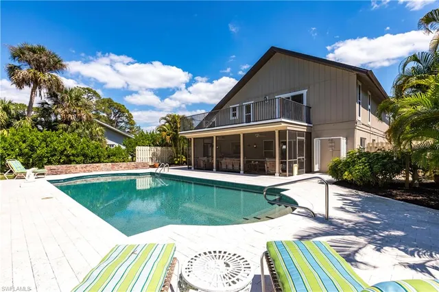 a swimming pool with outdoor seating and yard