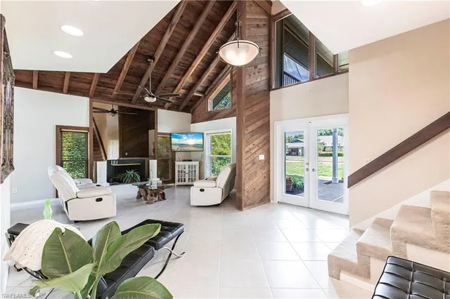a living room with furniture and a floor to ceiling window