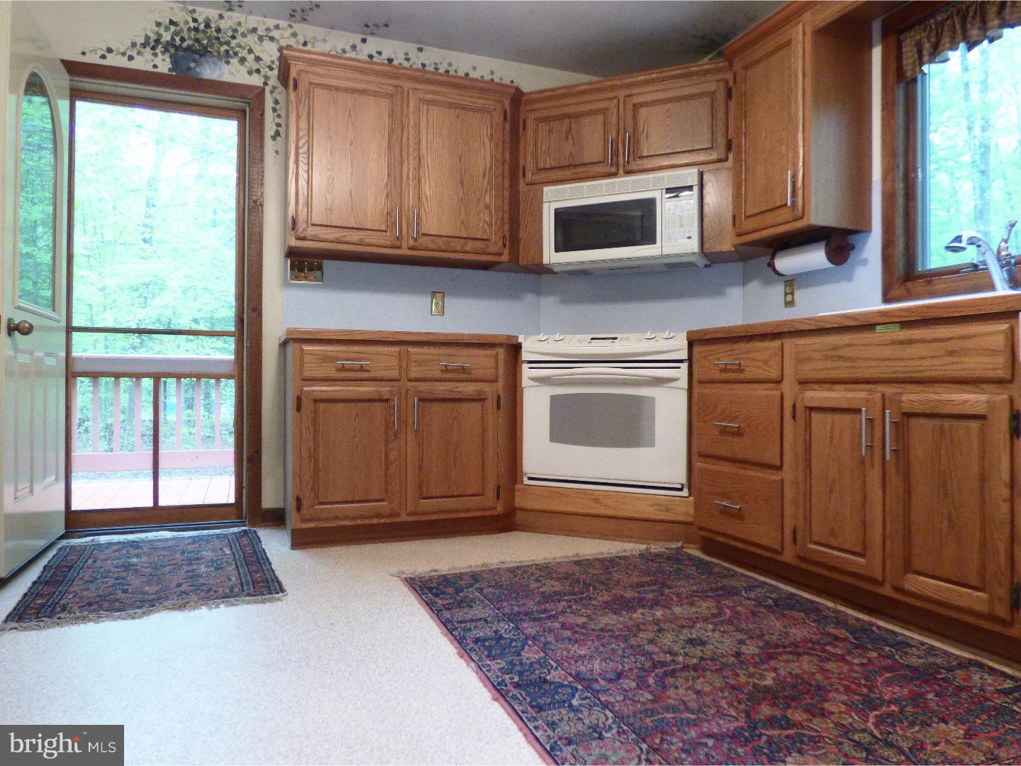 124 Alloway-Woodstown Road Alloway, NJ 08098 - Photo 18 of 25 a kitchen with stainless steel appliances granite countertop a stove a sink and a microwave