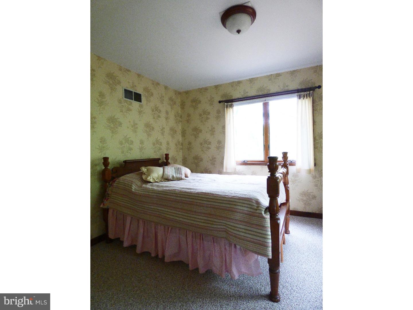 124 Alloway-Woodstown Road Alloway, NJ 08098 - Photo 21 of 25 a bedroom with a bed and a window